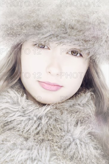 Close up of Caucasian girl wearing fur hat and scarf