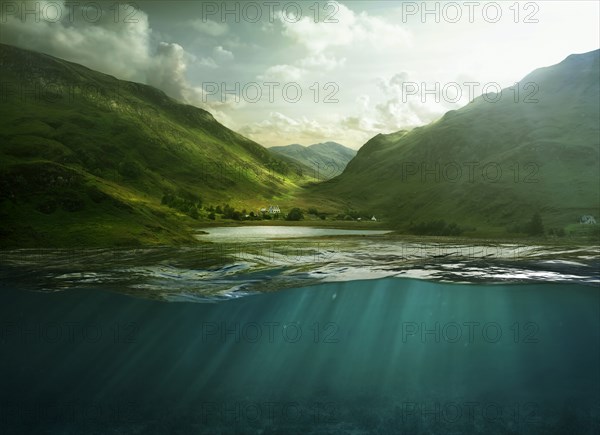 Sunbeams shining through surface of still remote lake