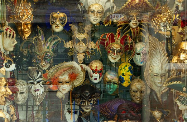 Decorative masks hanging in store window