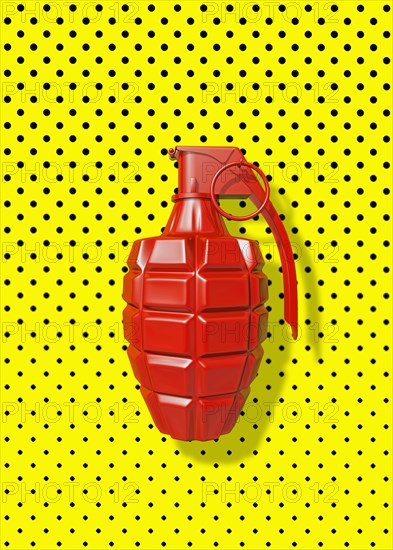Close up of red grenade on polka dot background