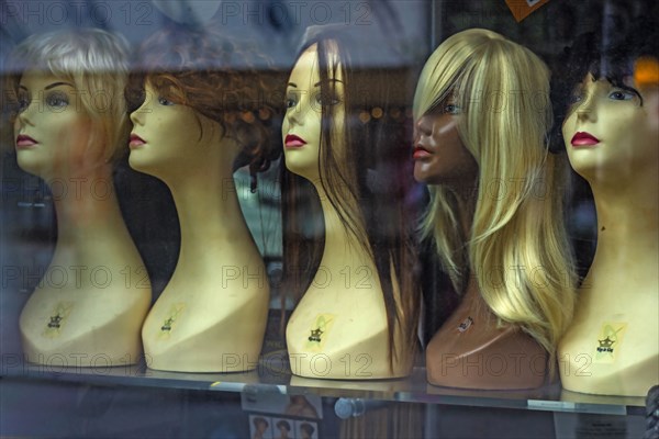 Mannequins and wigs in store window