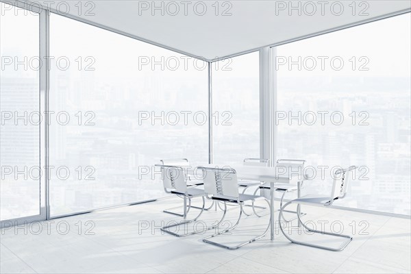 Empty chairs and conference table in office