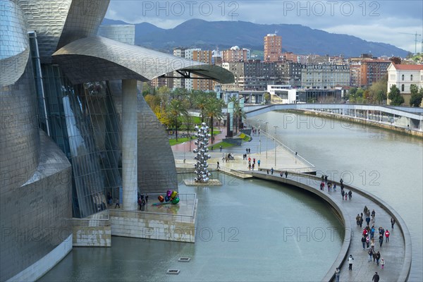 Aerial view of tourists on walkway over urban canal