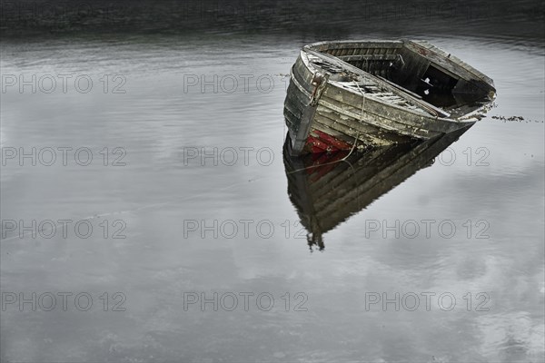 Dilapidated boat in lake