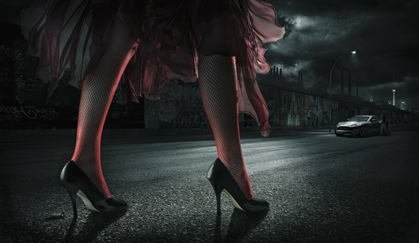 Woman wearing high heels on street at night