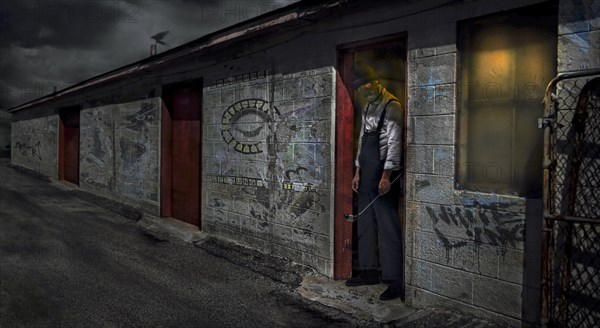 Man standing in dilapidated building doorway