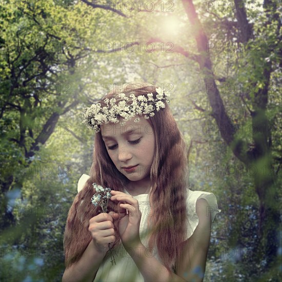 Caucasian girl wearing flower crown in forest