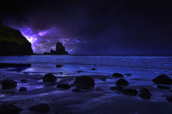 Night sky over rocky Carbost coastline