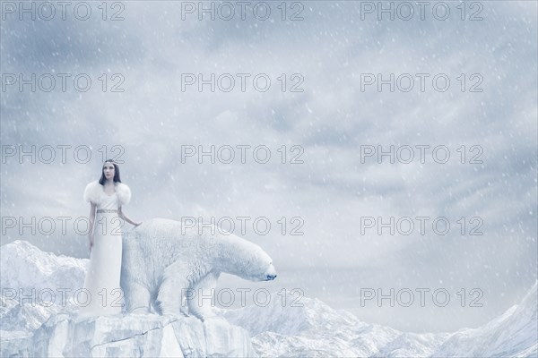 Woman and polar bear standing on glacier