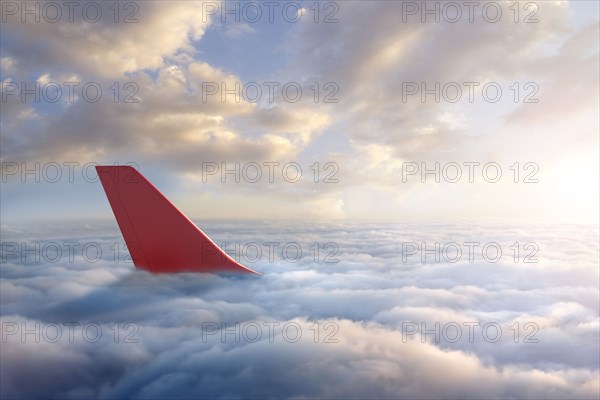 Airplane rudder above clouds