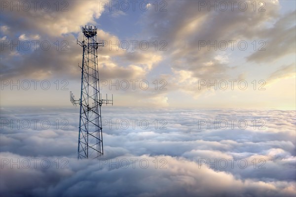 Cellular tower above clouds