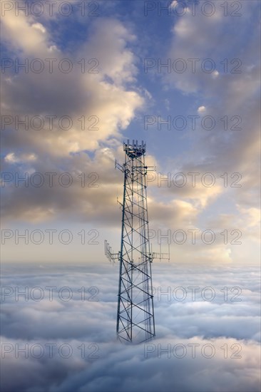 Cellular tower above clouds