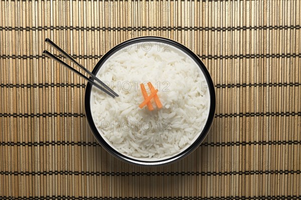 Chopsticks in bowl of white rice