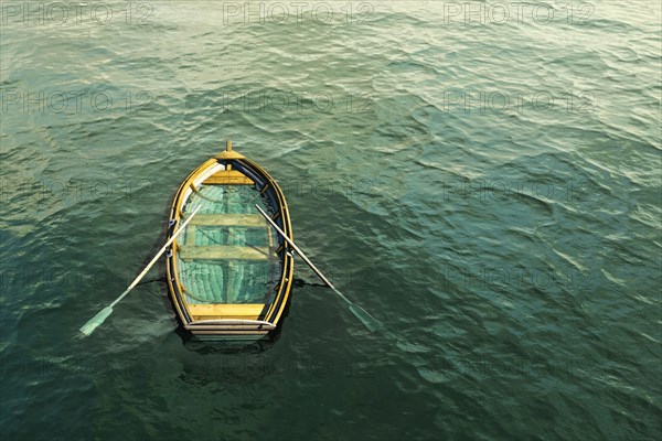 Abandoned sinking rowboat in ocean