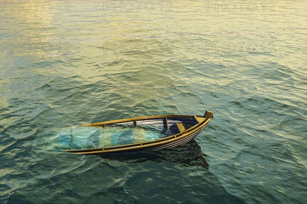 Abandoned sinking rowboat in ocean