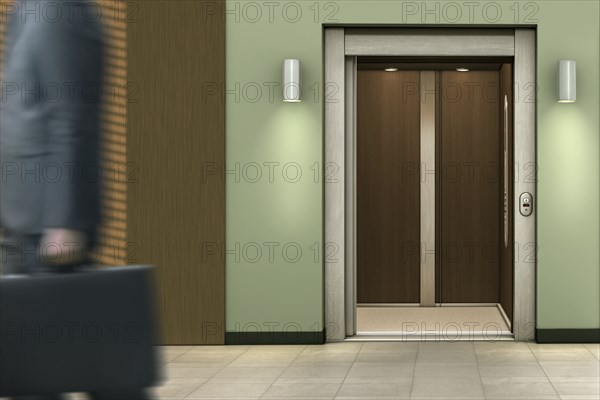 Businessman passing open elevator