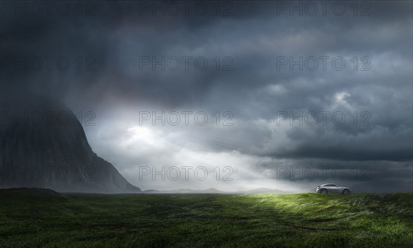 Silver sports car in lush green landscape