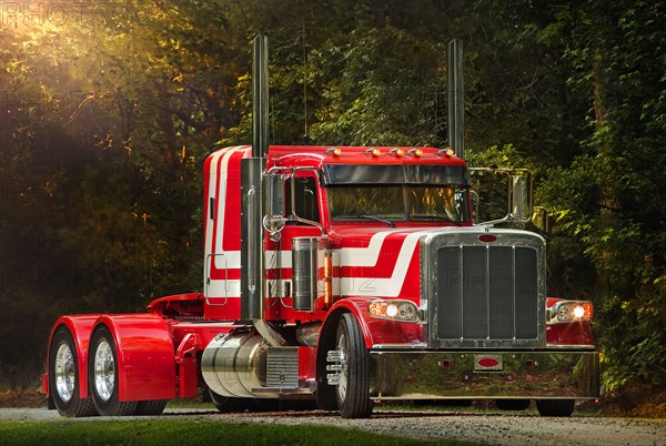 Semi-truck driving on dirt road