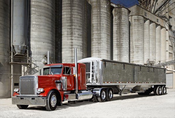 Semi-truck at industrial silos