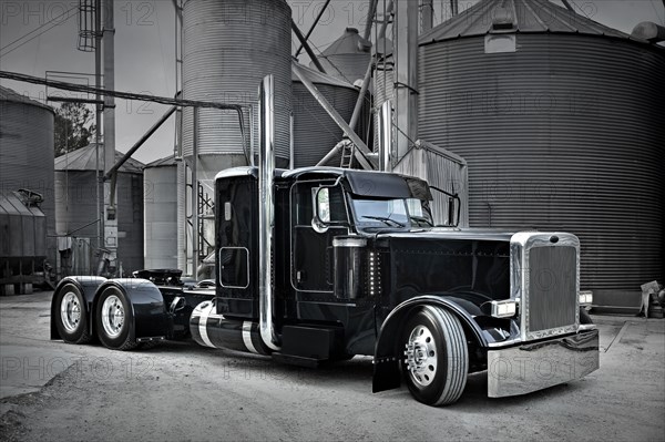 Semi-truck at industrial silos