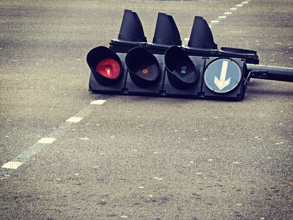 Traffic light laying in street intersection