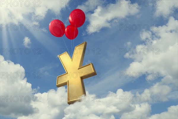 Red balloons lifting yuan symbol in cloudy sky