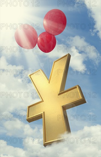 Red balloons lifting yuan symbol in cloudy sky