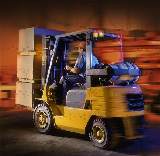 Caucasian forklift driver moving pallets