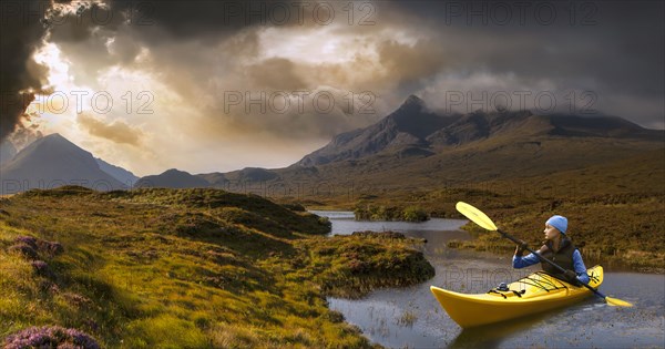 Caucasian girl in kayak on mountain river