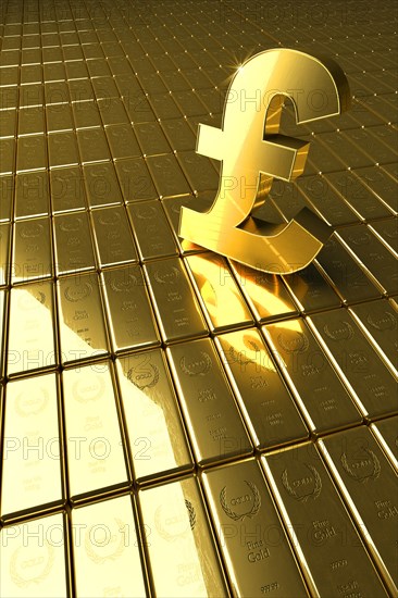High angle view of gold bars and British pound symbol