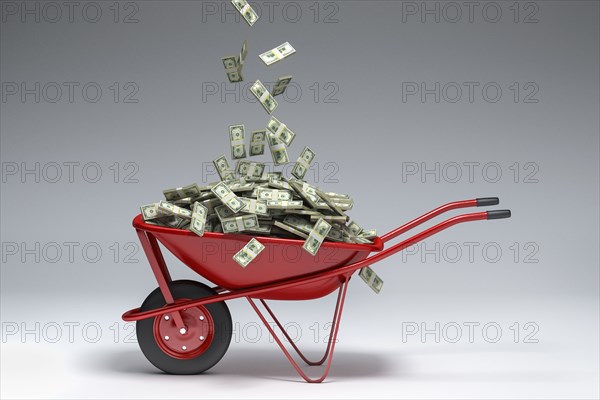 Dollars falling into red wheelbarrow