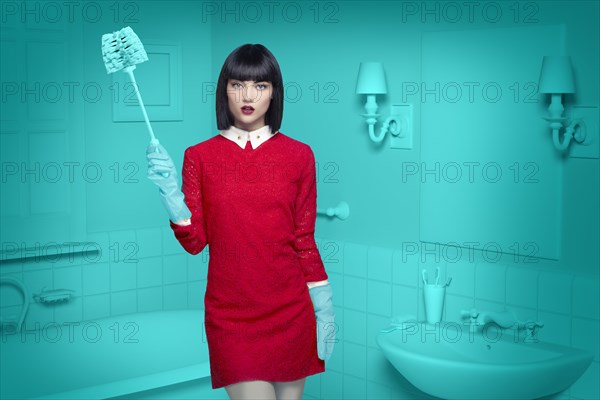 Caucasian woman in teal old-fashioned bathroom holding cleaning brush