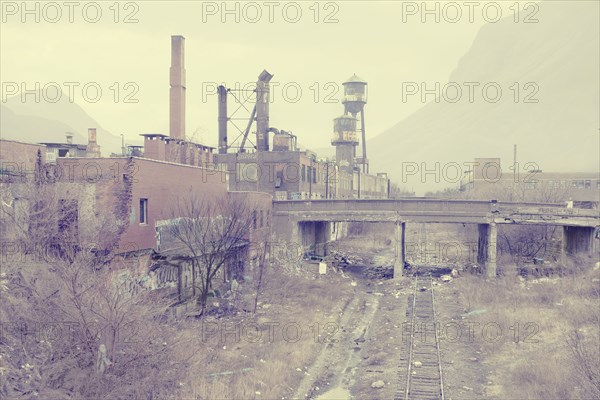 Dilapidated factory near railroad tracks