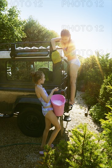 Caucasian girls washing truck