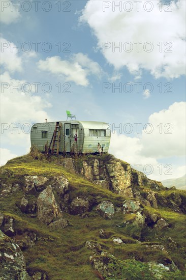 Motor home on hill in green landscape