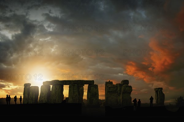 Silhouette of people during sunset at Stonehenge