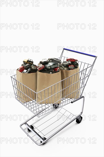 Paper bags in shopping cart filled with cars