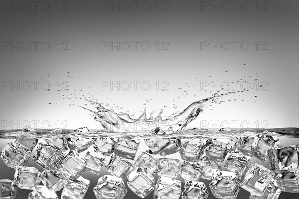 Ice cubes splashing into water and floating