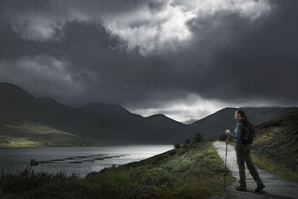 Caucasian woman hiking on path near river