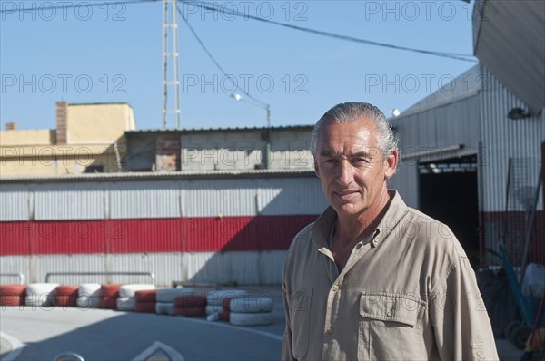 Hispanic mechanic on racetrack