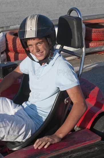 Hispanic teenager on go-cart track