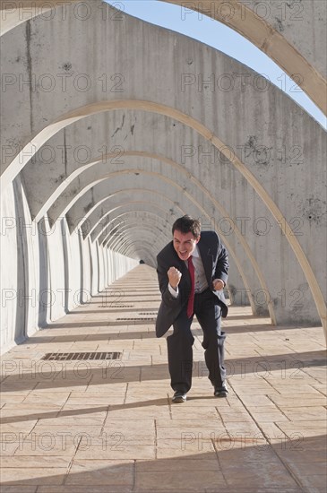 Hispanic businessman cheering at success