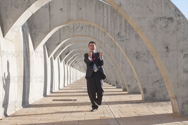 Hispanic businessman cheering at success