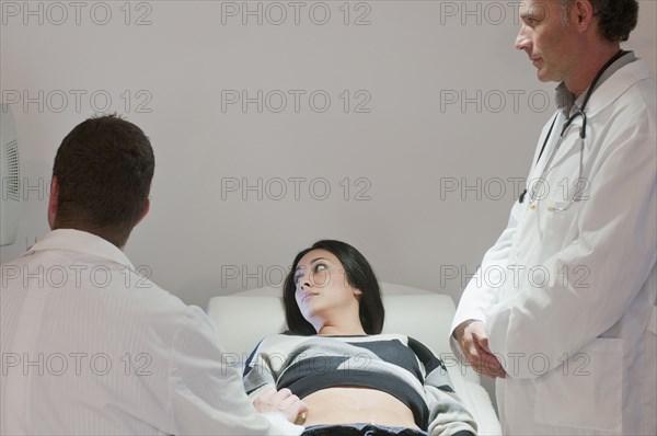 Doctors examining pregnant woman