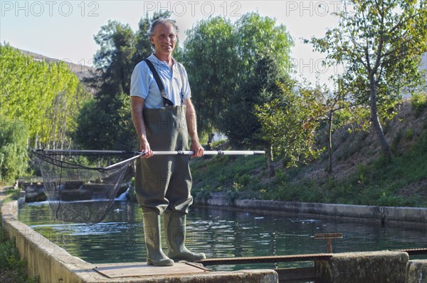 Hispanic fisherman holding net