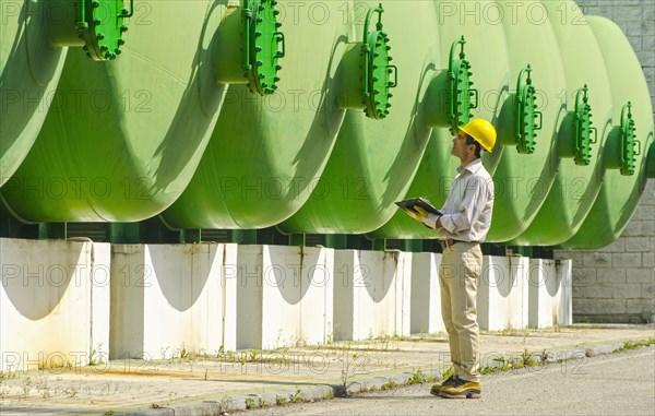 Hispanic worker checking tanks