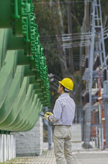 Hispanic worker checking tanks