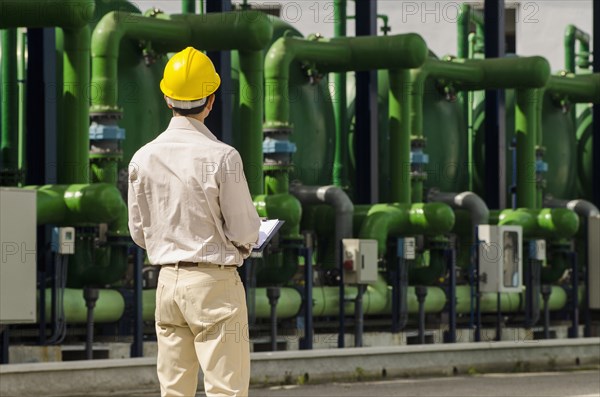 Hispanic worker wearing hard hat outdoors