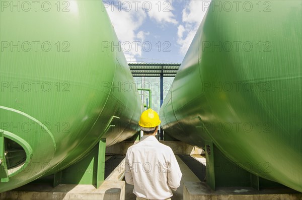 Hispanic worker checking tanks