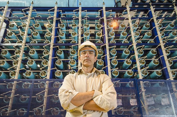 Hispanic worker standing in factory